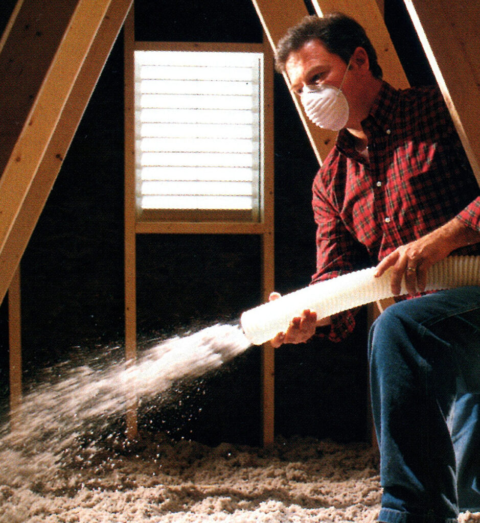 contractor spraying foam insulation in attic in home